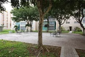 a view of a park with bench and trees
