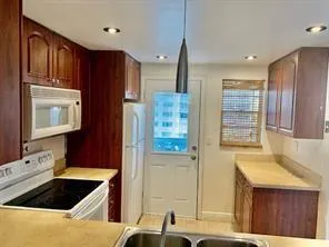 a kitchen with stainless steel appliances granite countertop a sink and a stove