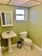 a bathroom with a sink toilet and mirror