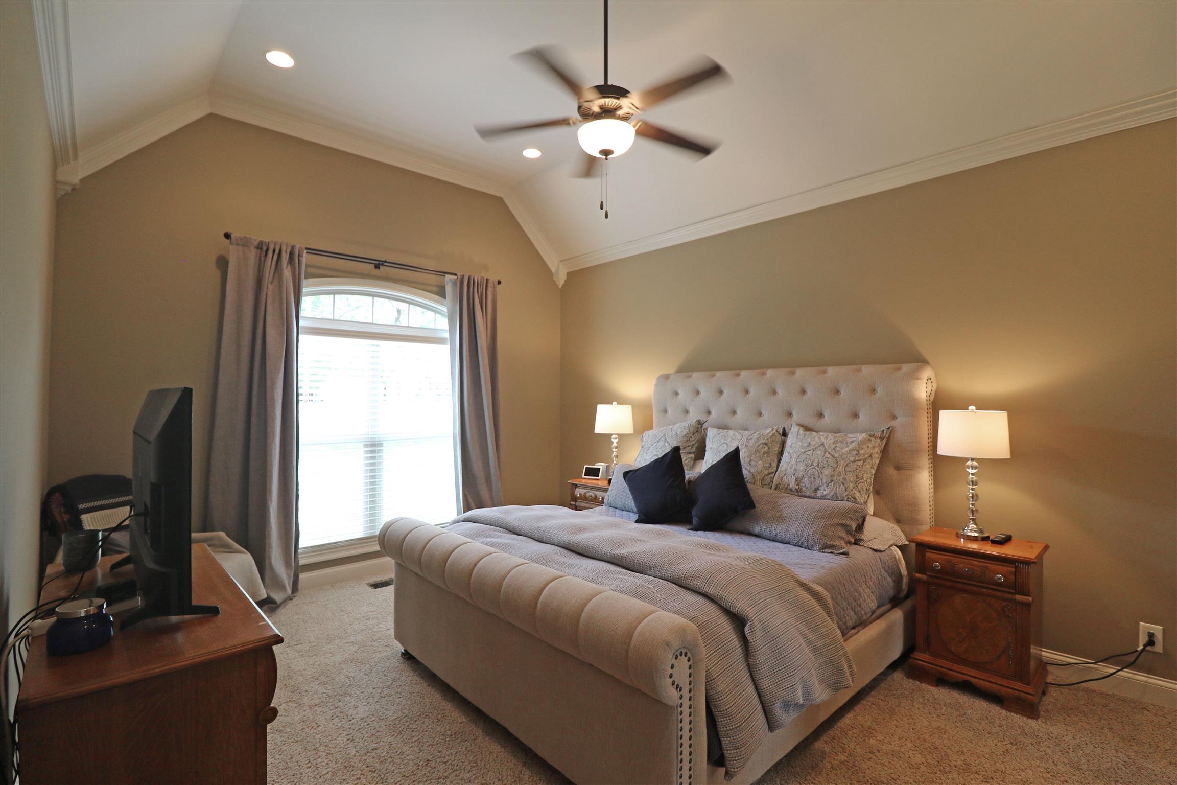 1235 Mires Road Mount Juliet, TN 37122 - Photo 15 of 30 Master Bedroom: 18 x 13 Gorgeous owner’s suite with plush carpeting, double window with faux wood blinds and a lazy brow transom, pitched ceiling with ceiling fan/light, recessed lighting, and crown molding.