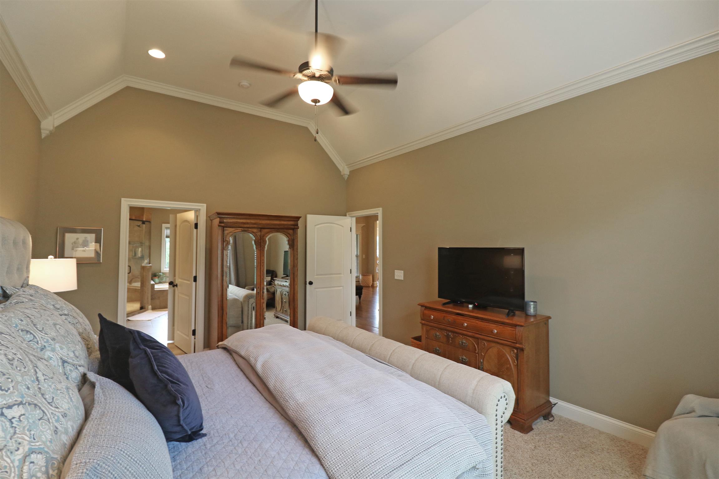 1235 Mires Road Mount Juliet, TN 37122 - Photo 16 of 30 Master Bedroom: 18 x 13 Gorgeous owner’s suite with plush carpeting, double window with faux wood blinds and a lazy brow transom, pitched ceiling with ceiling fan/light, recessed lighting, and crown molding.