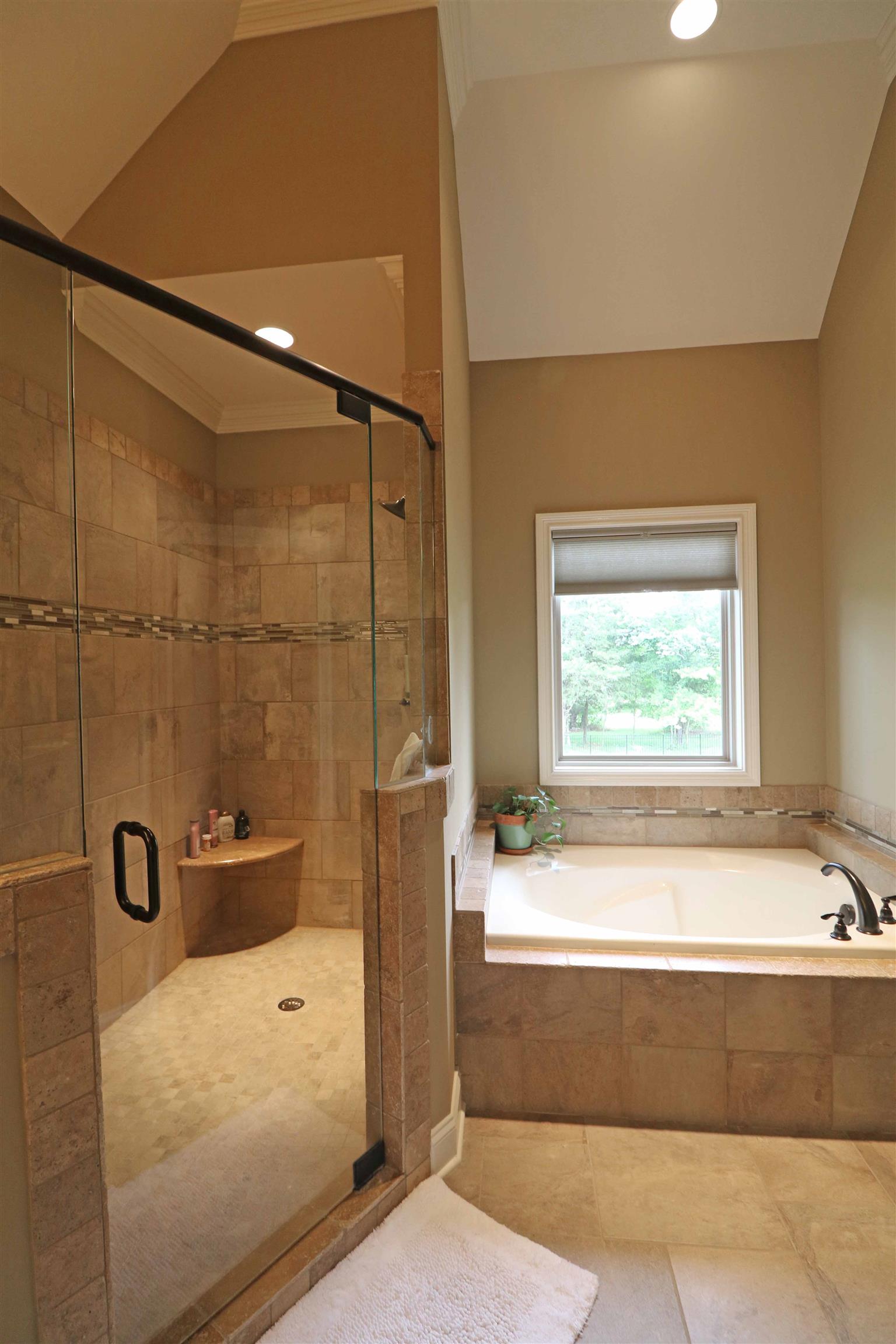 1235 Mires Road Mount Juliet, TN 37122 - Photo 18 of 30 Luxurious bathroom with tile flooring, crown molding, double bowl granite vanity, a separate linen closet, a large jetted tub with tile surrounds, an oversized walk-in tiled shower with a heavy glass door & bench seat, a separate water closet