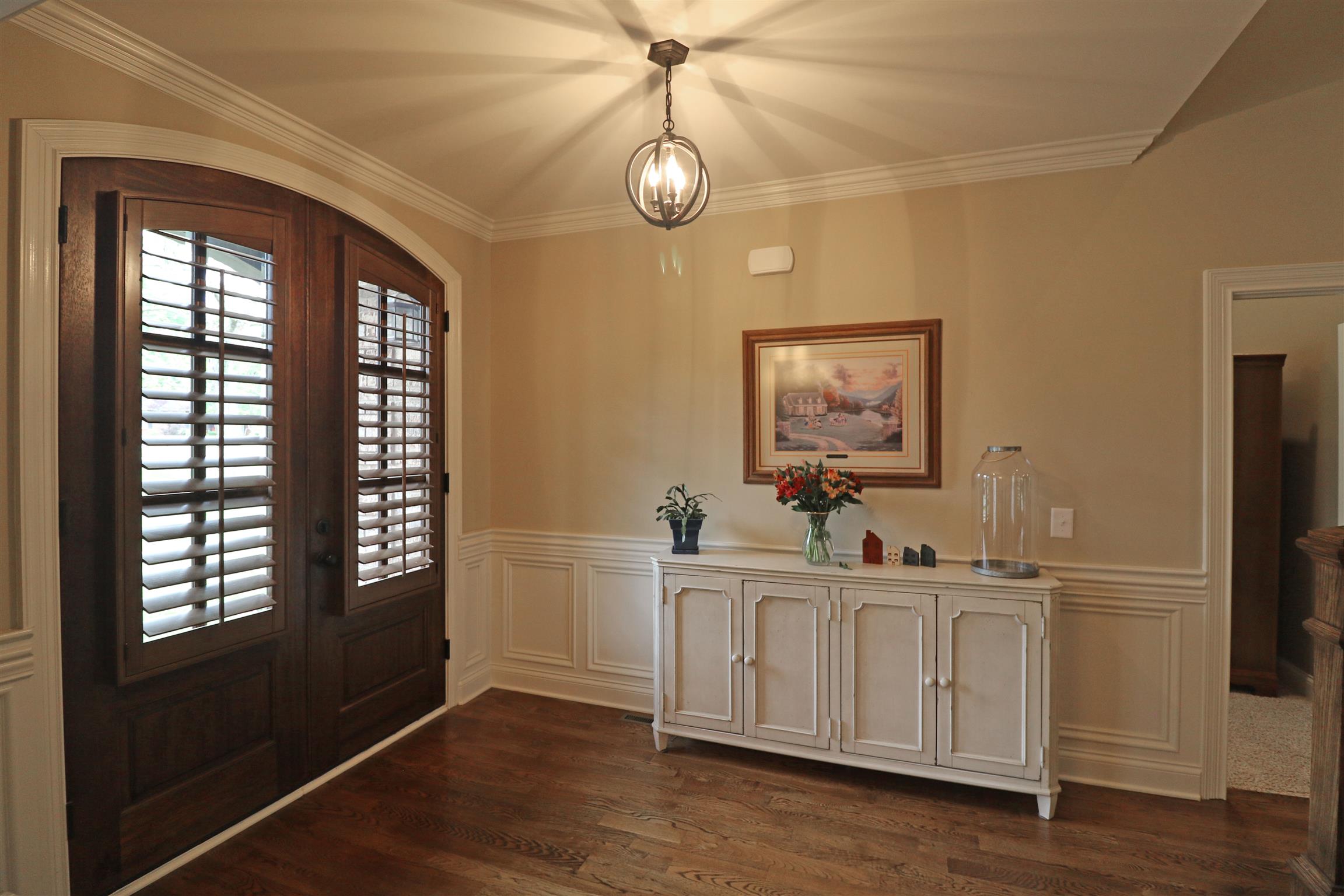 1235 Mires Road Mount Juliet, TN 37122 - Photo 3 of 30 Inviting entry foyer with hardwood flooring, crown molding, wainscoting, and a solid wood double entry door with stained wood blinds.