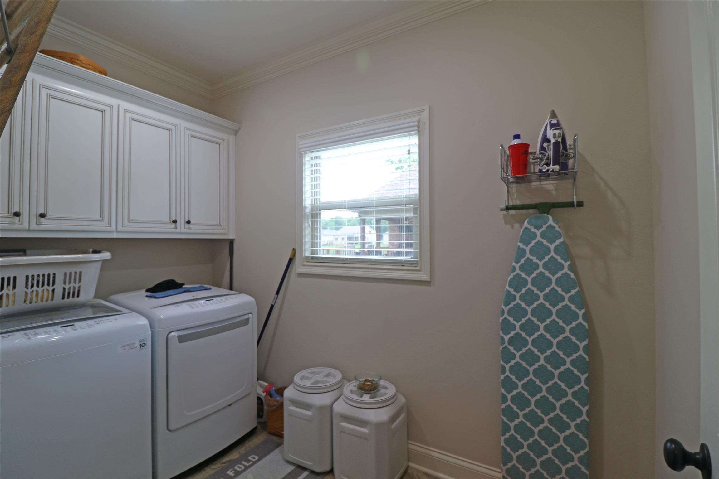 1235 Mires Road Mount Juliet, TN 37122 - Photo 30 of 30 Upgraded 10 x 6 utility room faux wood blinds, upper wall cabinets above the washer and dryer area, and crown molding.