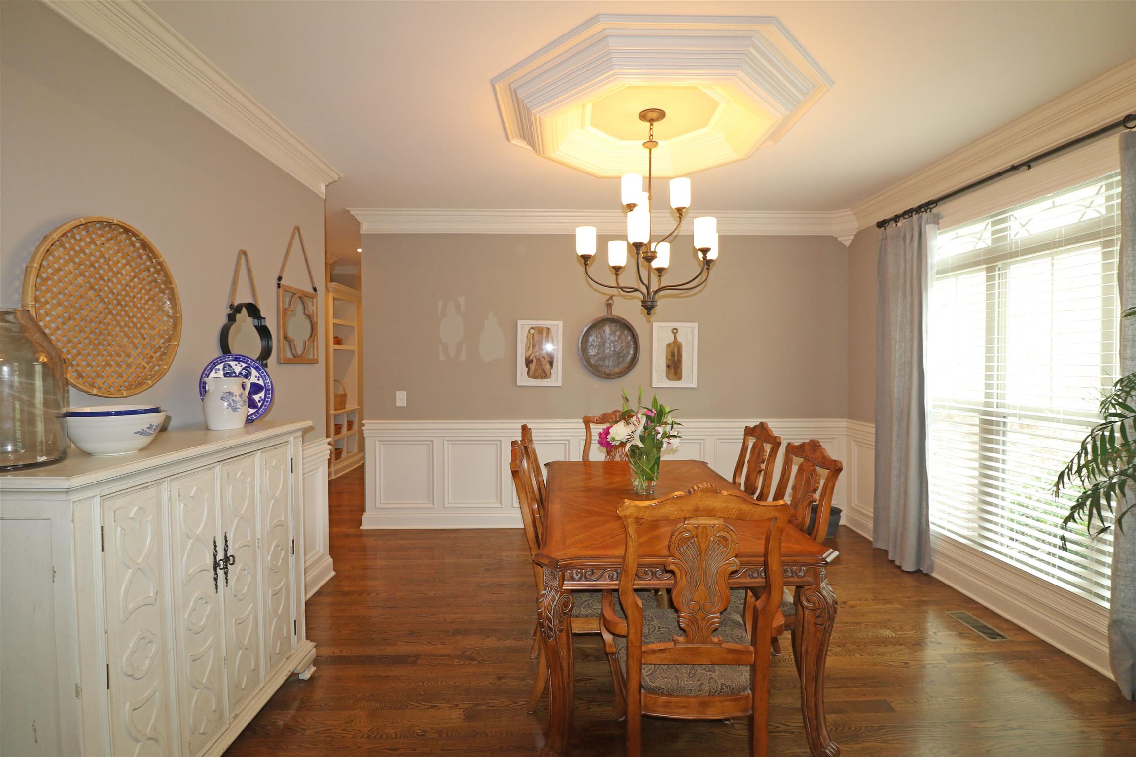 1235 Mires Road Mount Juliet, TN 37122 - Photo 5 of 30 Dining Room: 13 x 12. Elegant Formal Dining Room with wainscoting, triple window with faux wood blinds and transoms, crown molding, ceiling medallion, hardwood flooring, and a large cased opening into the Foyer area.