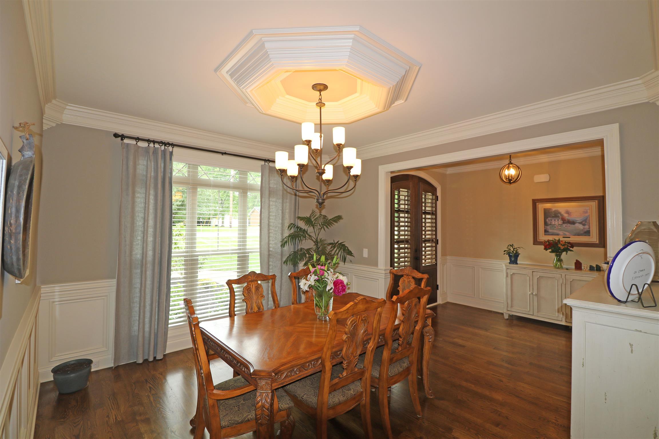 1235 Mires Road Mount Juliet, TN 37122 - Photo 6 of 30 Dining Room: 13 x 12. Elegant Formal Dining Room with wainscoting, triple window with faux wood blinds and transoms, crown molding, ceiling medallion, hardwood flooring, and a large cased opening into the Foyer area.