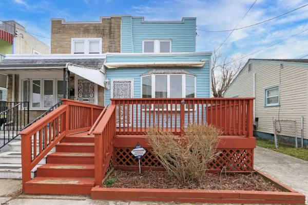 a view of a house with wooden deck