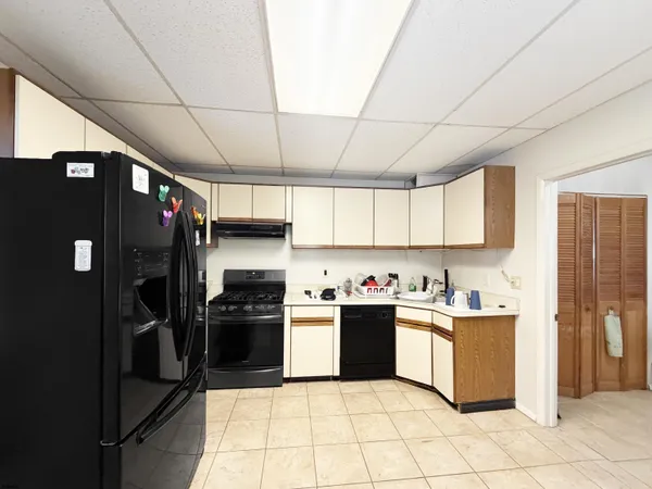 a kitchen with stainless steel appliances granite countertop a refrigerator and a stove top oven