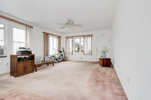 a view of a livingroom with furniture and windows