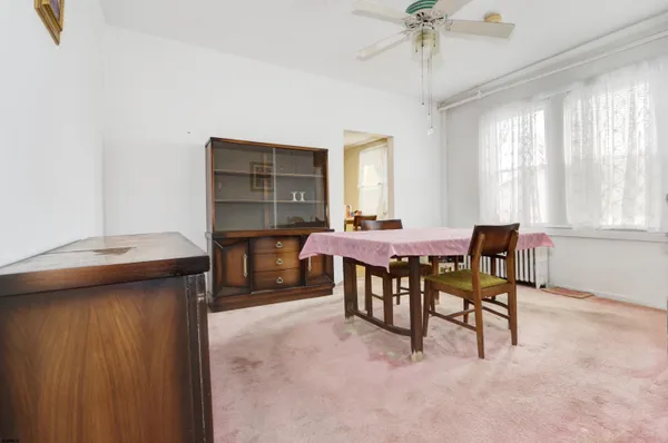 a dining room with furniture and window