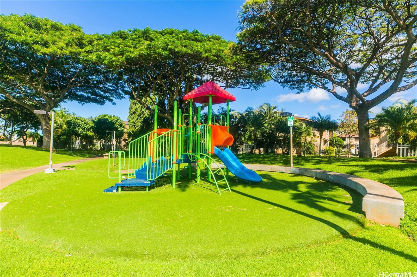 91-1101 Namahoe Street, Unit 3H Kapolei, HI 96707 - Photo 22 of 25 a view of a park with swings and slides