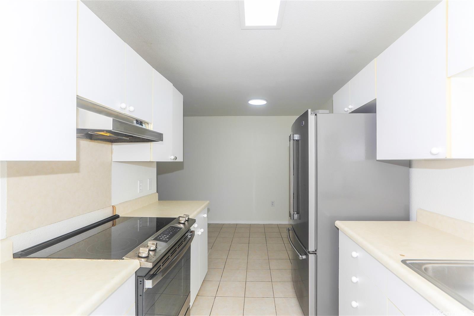 91-1101 Namahoe Street, Unit 3H Kapolei, HI 96707 - Photo 3 of 25 a kitchen with a stove and a refrigerator