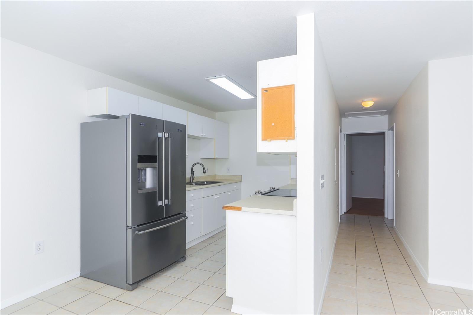 91-1101 Namahoe Street, Unit 3H Kapolei, HI 96707 - Photo 4 of 25 a kitchen with a refrigerator and a more cabinets