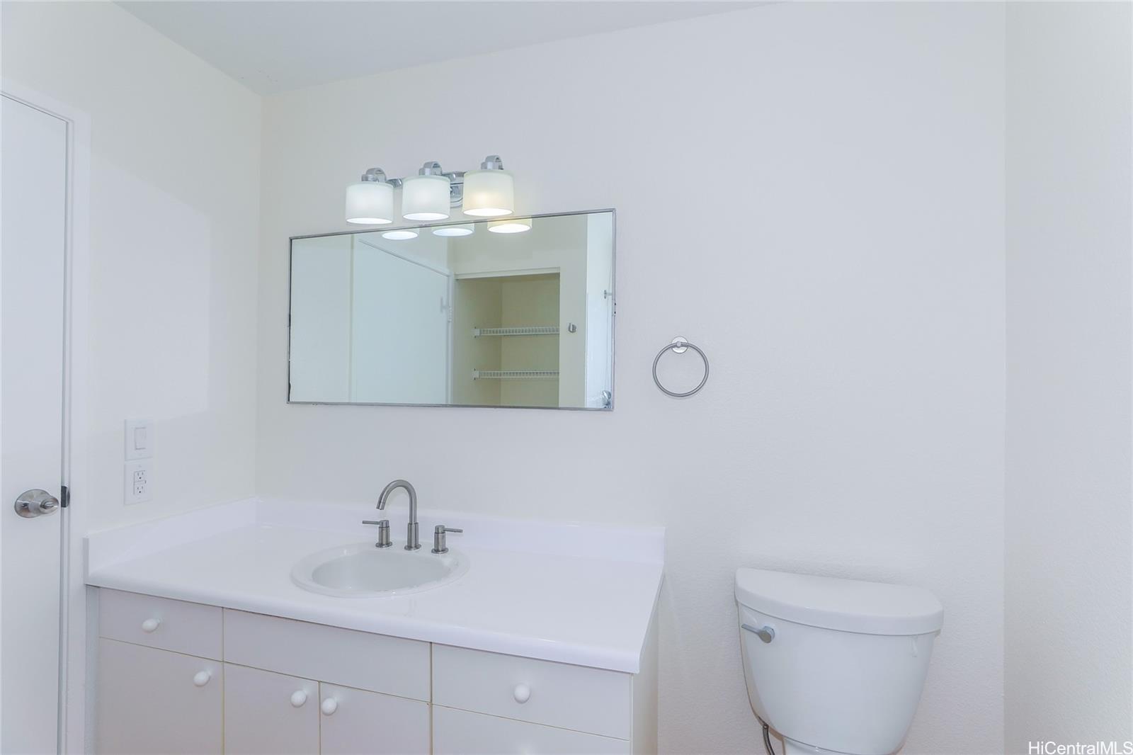 91-1101 Namahoe Street, Unit 3H Kapolei, HI 96707 - Photo 6 of 25 a bathroom with a toilet sink and mirror