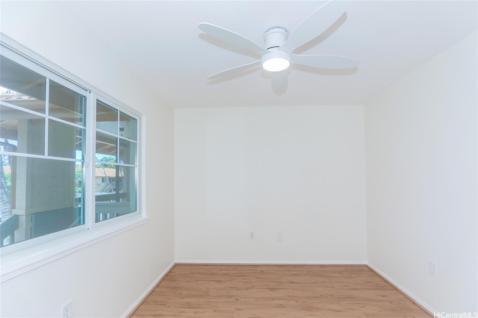 91-1101 Namahoe Street, Unit 3H Kapolei, HI 96707 - Photo 7 of 25 a view of an empty room with wooden floor and a window