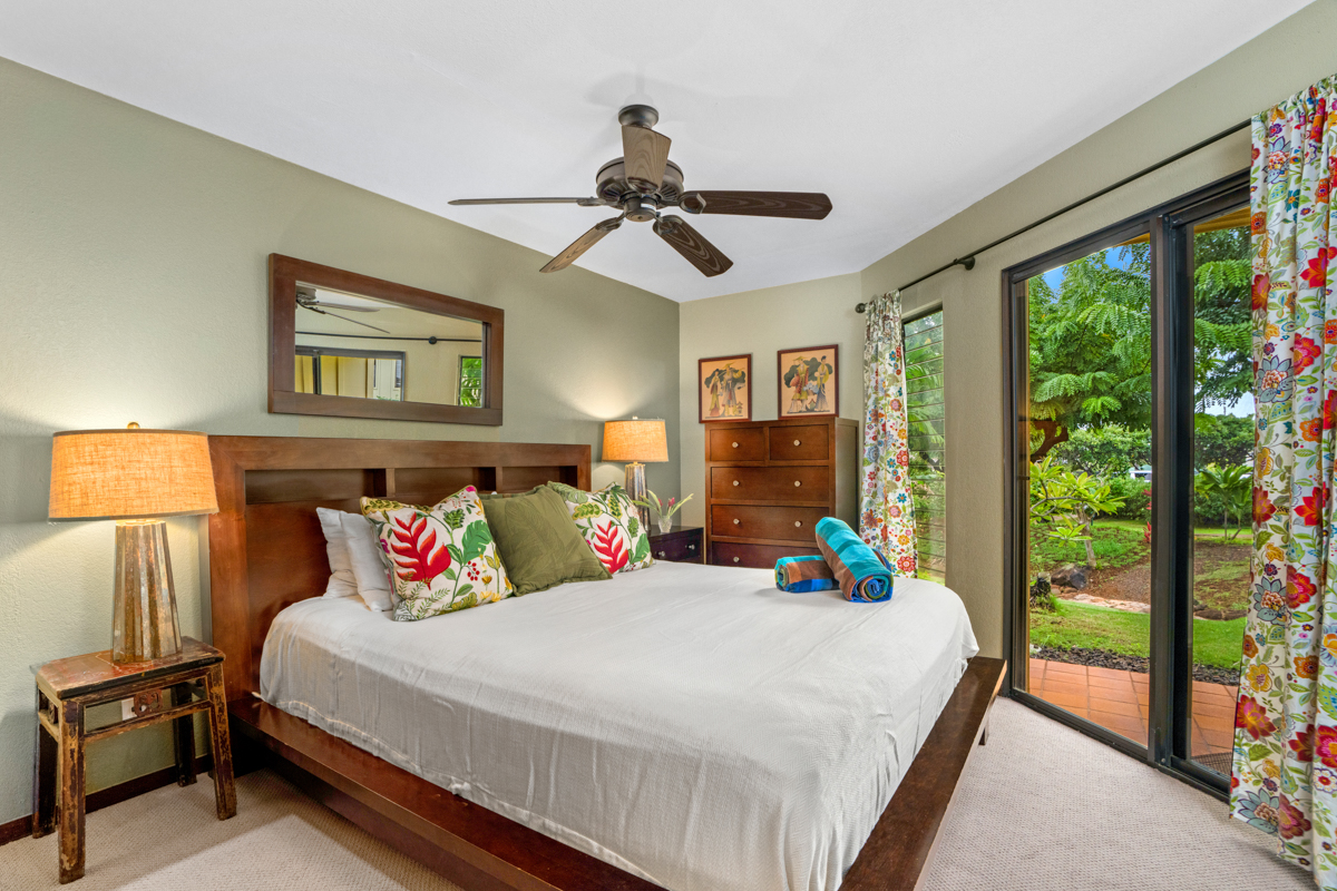 1870 Hoone Road, Unit 602 Koloa, HI 96756 - Photo 14 of 26 a bedroom with a bed and large windows