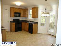 9436 Dunroming Road Chesterfield, VA 23832 - Photo 4 of 9 a kitchen with a stove and a chandelier