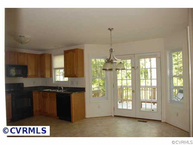 9436 Dunroming Road Chesterfield, VA 23832 - Photo 6 of 9 a kitchen with refrigerator and window