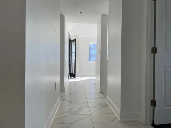 a kitchen with white cabinets and white appliances