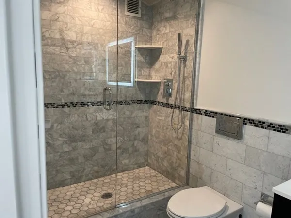 a bathroom with a toilet a sink and vanity