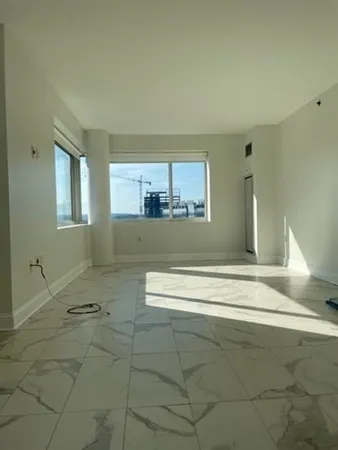 a view of a kitchen with a sink and chandelier