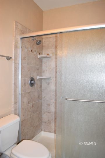 919 Sims Street Ridgecrest, CA 93555 - Photo 23 of 32 a bathroom with a toilet and a shower