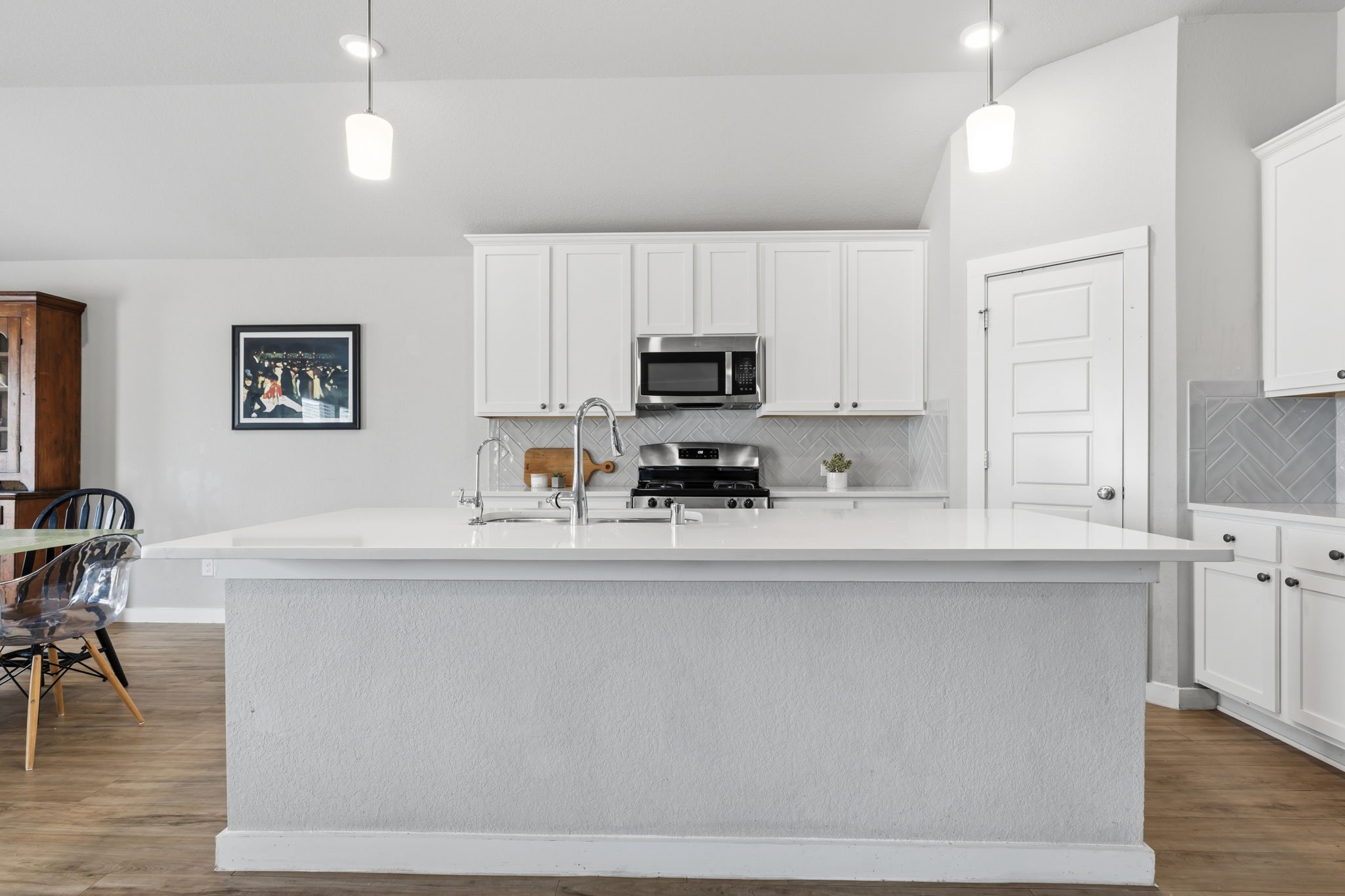 14914 Big Bend Ranch Drive Cypress, TX 77433 - Photo 5 of 49 a kitchen with kitchen island granite countertop a sink a counter top space and cabinets
