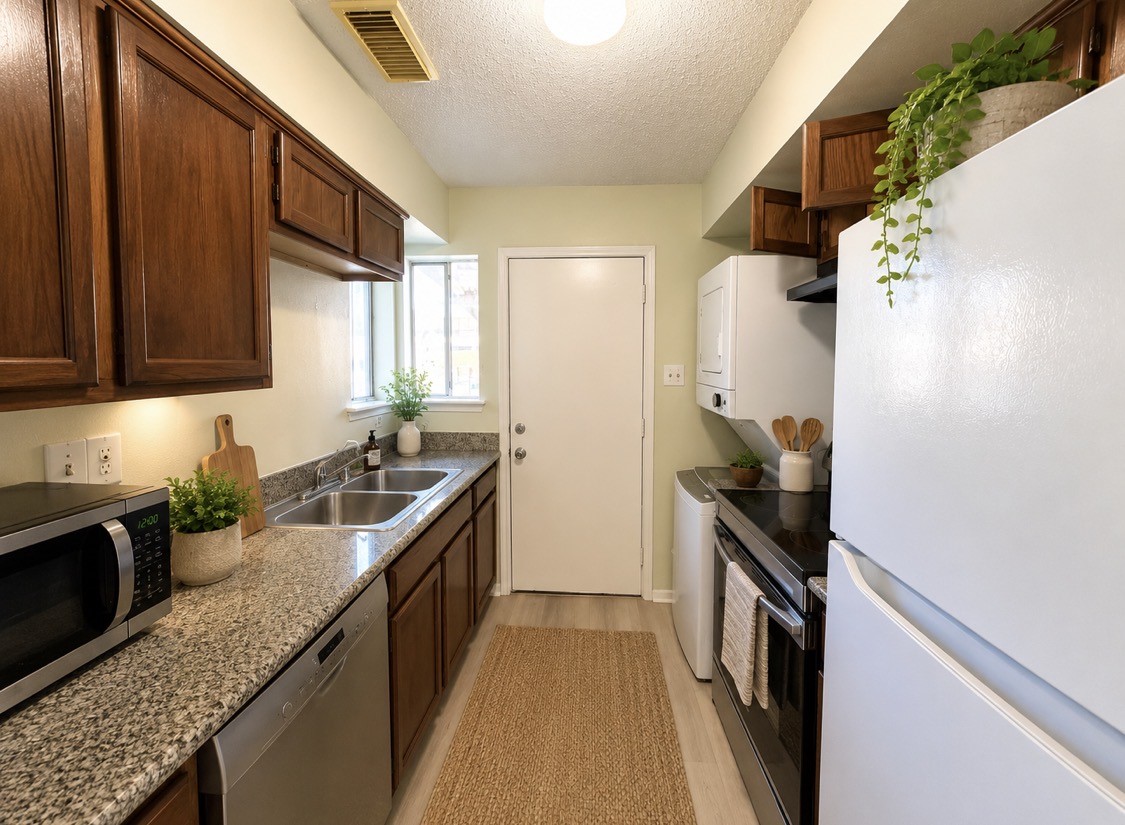 7789 Cook Road Houston, TX 77072 - Photo 9 of 18 a kitchen with granite countertop a sink a stove and refrigerator