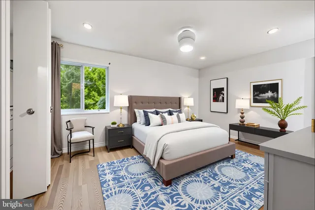 a living room with furniture a rug and a flat screen tv