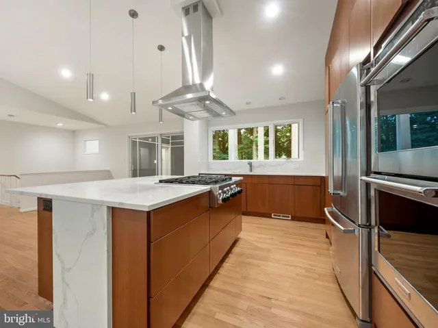 a bedroom with a bed a rug and wooden floor