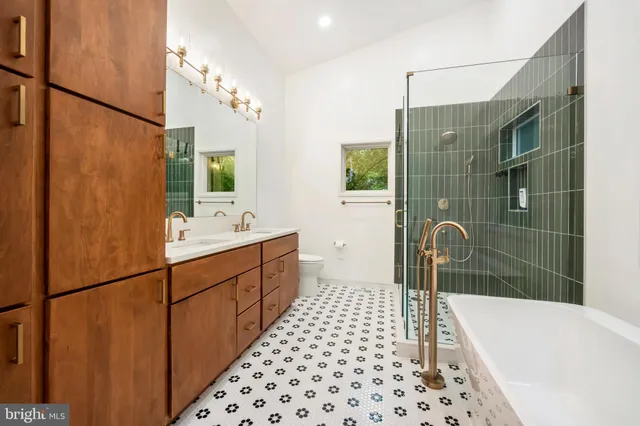 a large kitchen with stainless steel appliances a large counter top a stove and a refrigerator