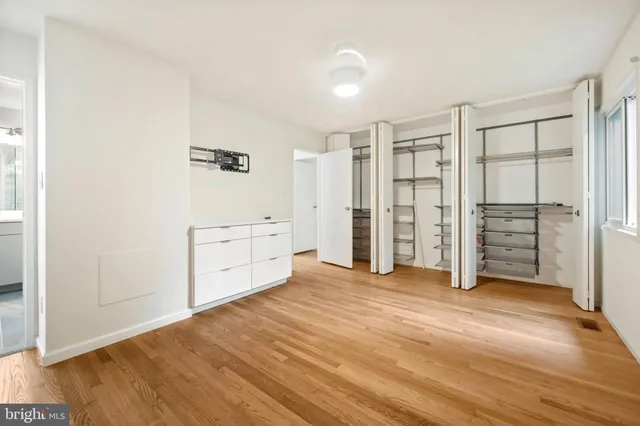 a view of walk in closet with empty racks