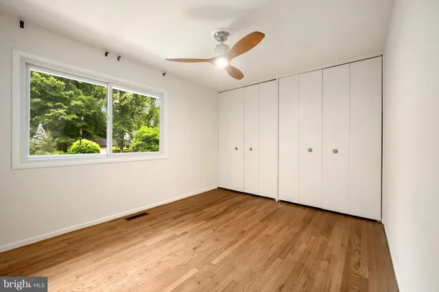 a bathroom with a granite countertop toilet sink and mirror