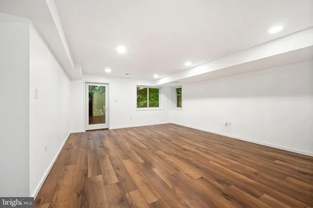 a view of a room with wooden floor