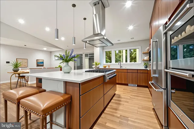 a large kitchen with a table and chairs