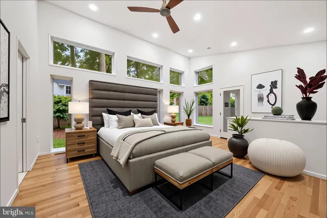 a living room with furniture a fireplace and a large window