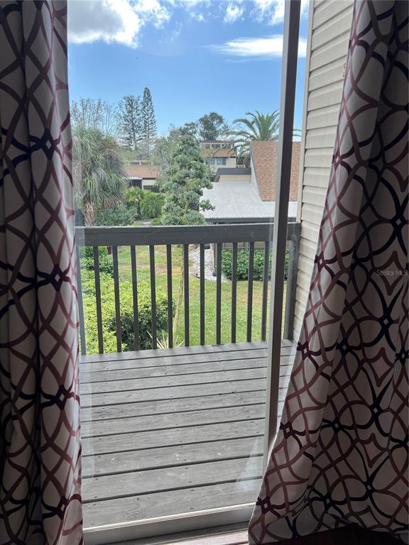 686 White Pine Tree Road, Unit 64 Venice, FL 34285 - Photo 14 of 20 a view of a balcony with wooden floor and fence