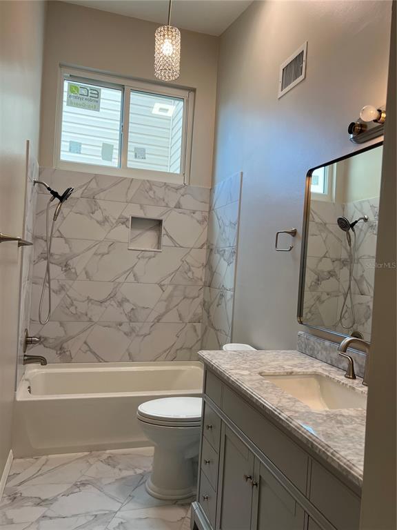 686 White Pine Tree Road, Unit 64 Venice, FL 34285 - Photo 17 of 20 a bathroom with a granite countertop sink toilet and shower