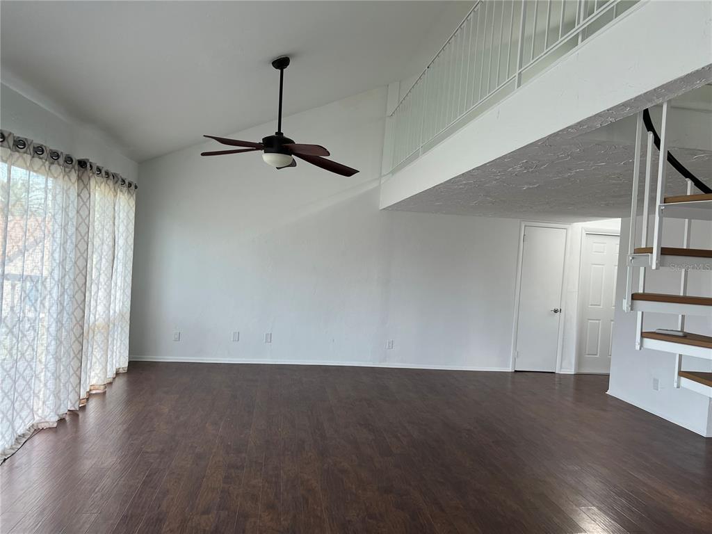 686 White Pine Tree Road, Unit 64 Venice, FL 34285 - Photo 4 of 20 a view of empty room with wooden floor and fan