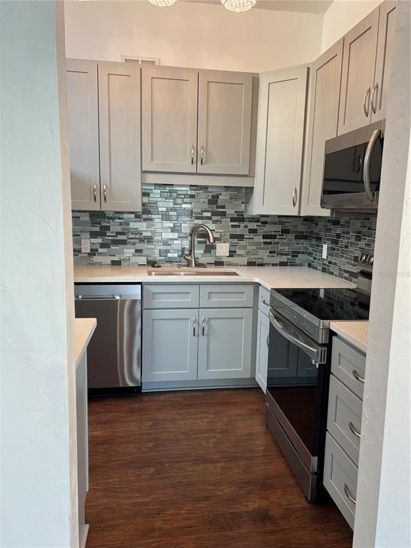 686 White Pine Tree Road, Unit 64 Venice, FL 34285 - Photo 10 of 20 a kitchen with stainless steel appliances granite countertop a stove top oven a sink dishwasher and a refrigerator