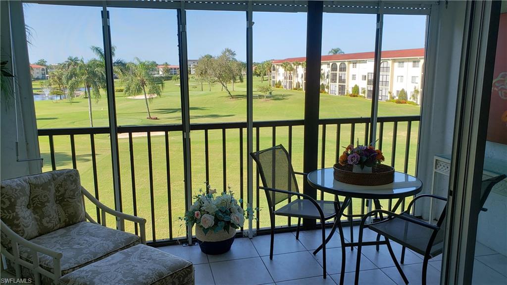 21 High Point Circle East, Unit 308 Naples, FL 34103 - Photo 2 of 31 Screened lanai with gorgeous view of the golf course.