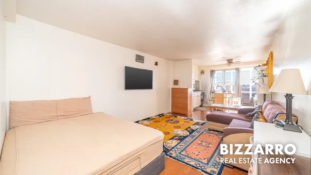 a bedroom with a bed window and flat screen tv