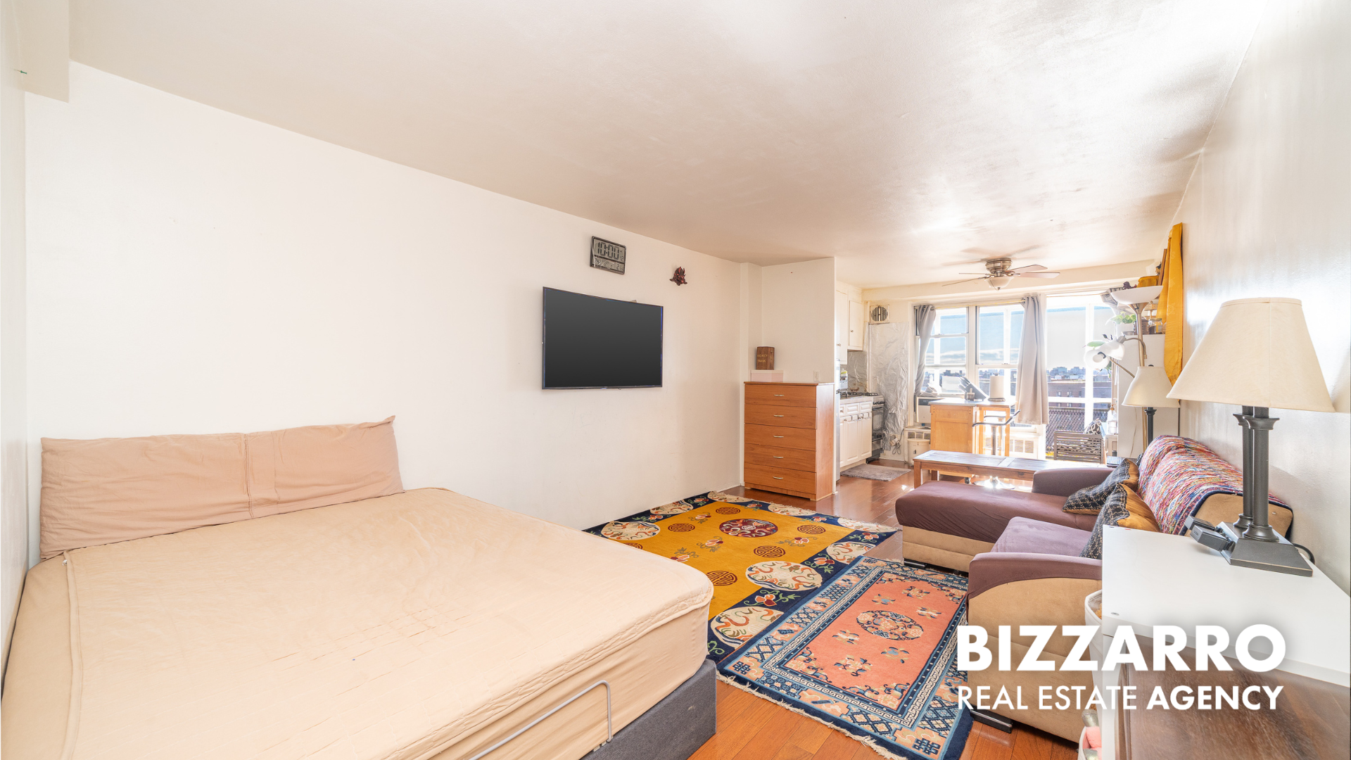 35-11 85th Street, Unit 9A Queens, NY 11372 - Photo 2 of 21 a bedroom with a bed window and flat screen tv