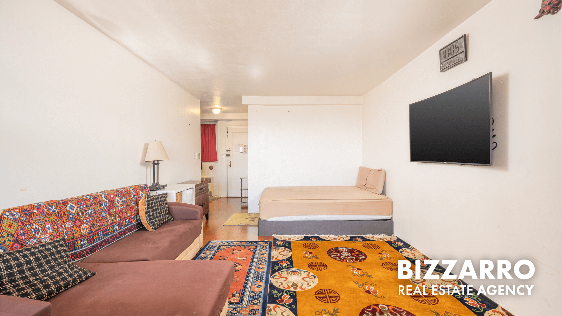 35-11 85th Street, Unit 9A Queens, NY 11372 - Photo 4 of 21 a living room with a couch and a flat screen tv