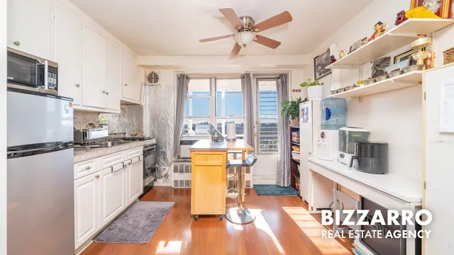 a large kitchen with stainless steel appliances granite countertop a lot of counter space and wooden floors