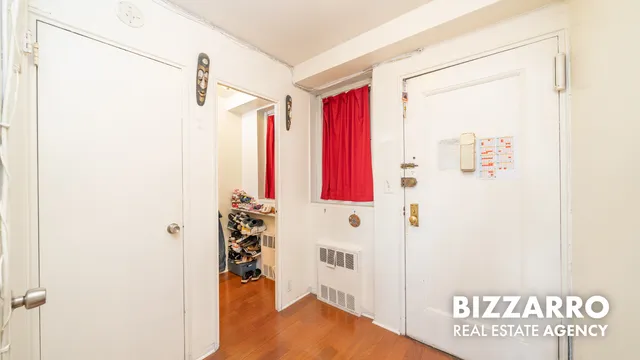 a view of a bedroom with wooden floor and windows