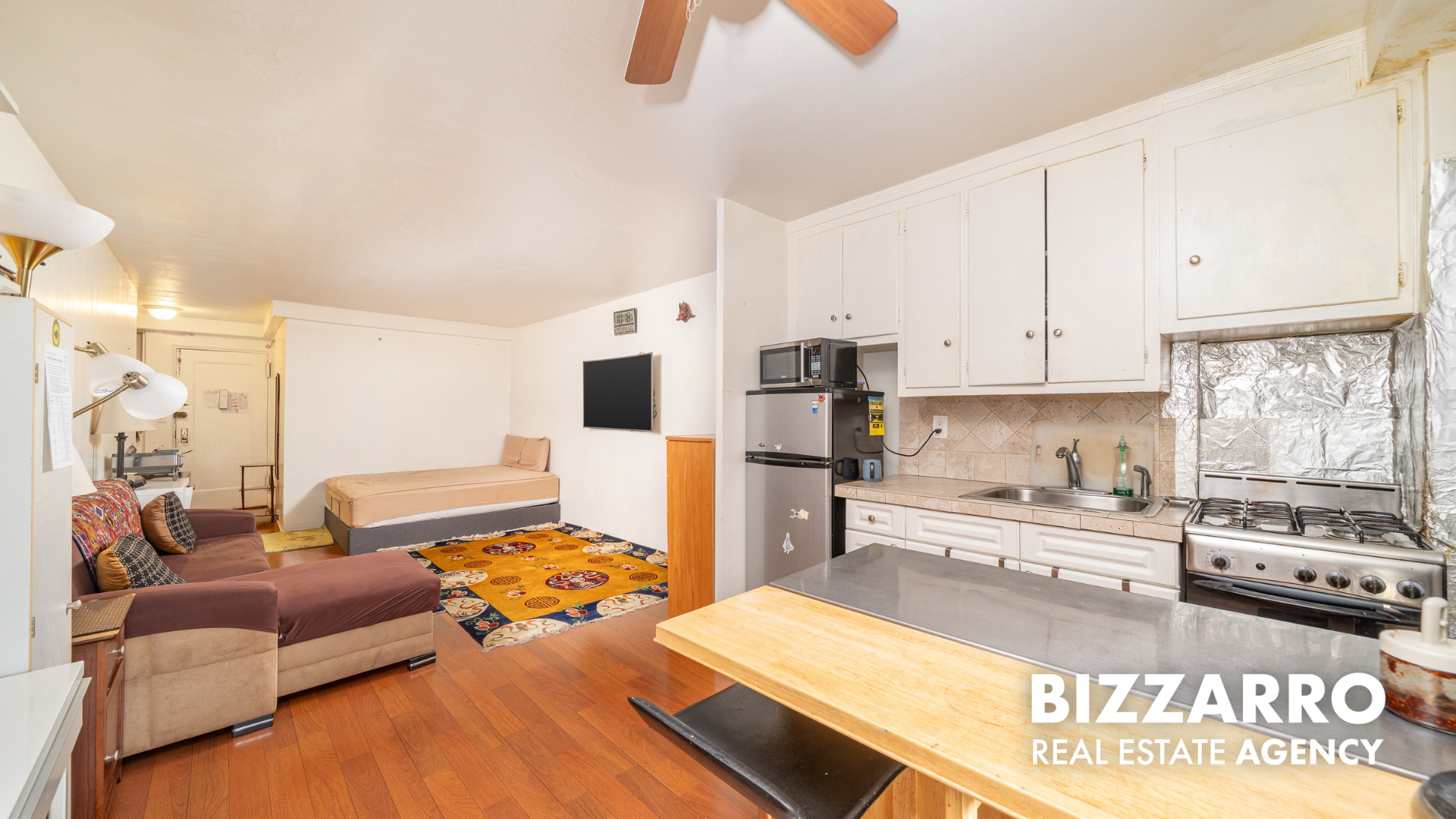 35-11 85th Street, Unit 9A Queens, NY 11372 - Photo 8 of 21 a kitchen with stainless steel appliances kitchen island granite countertop a refrigerator and a stove top oven