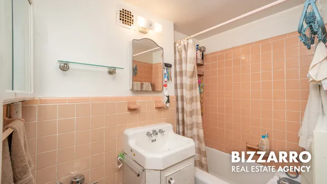 a bathroom with a sink a shower and a mirror