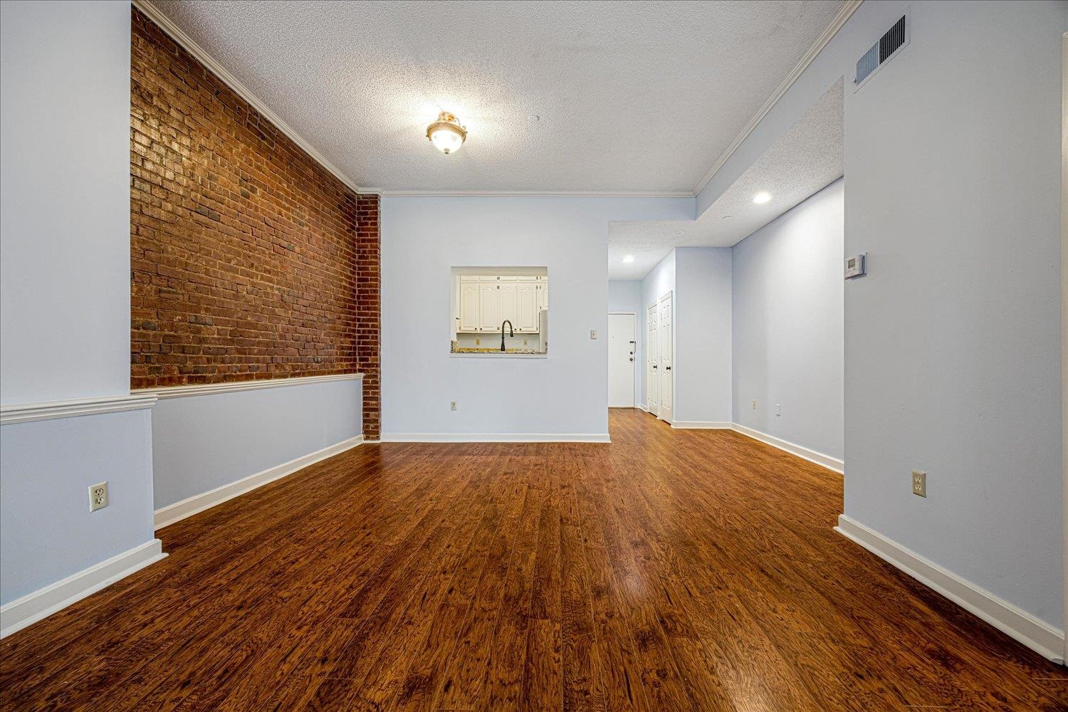 10 North Main Street, Unit 301 Memphis, TN 38103 - Photo 19 of 31 a view of empty room with wooden floor and fan