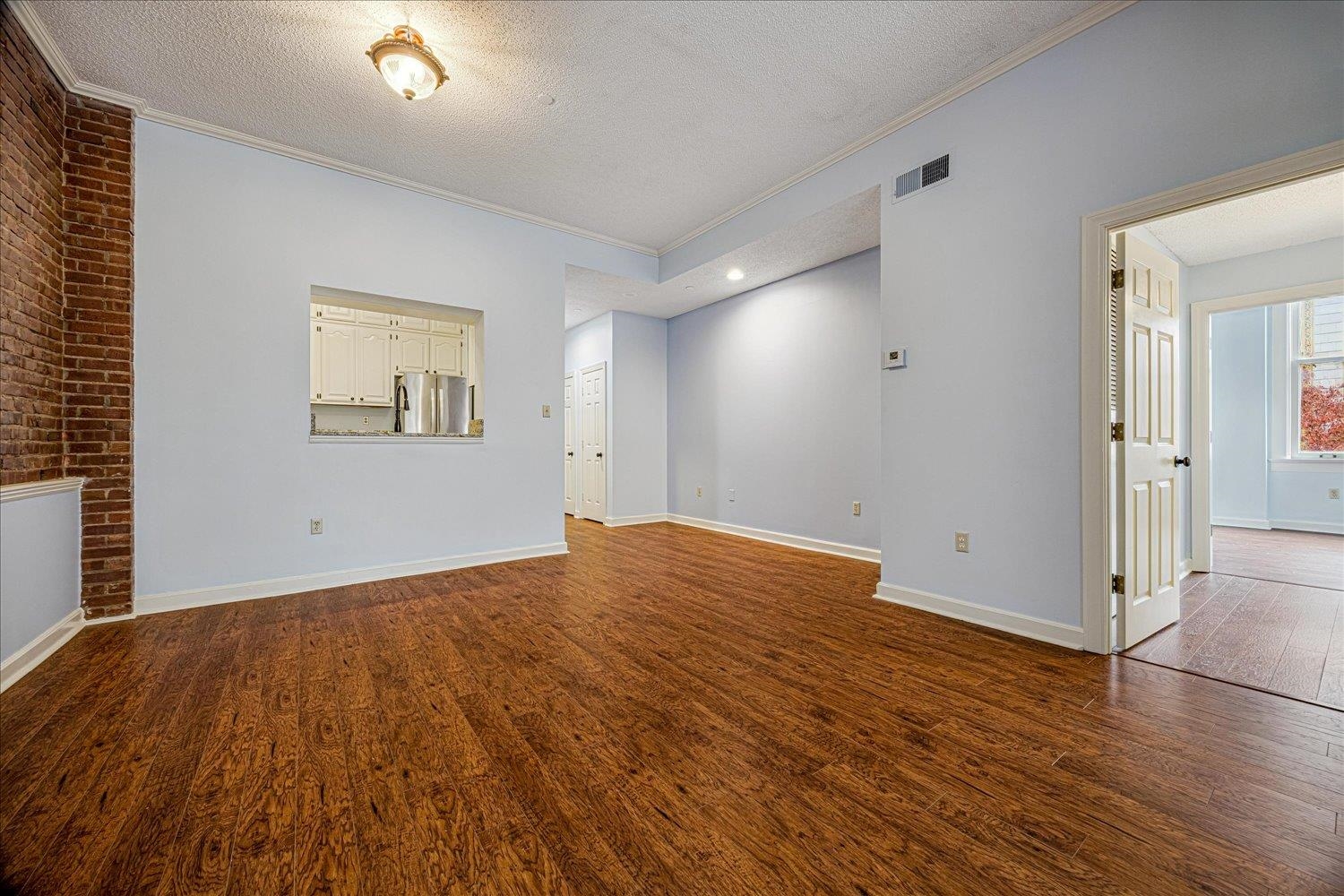 10 North Main Street, Unit 301 Memphis, TN 38103 - Photo 20 of 31 an empty room with wooden floor and windows
